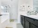 Bright bathroom featuring a double vanity, a walk-in shower and good storage space at 161 Williamson Dr, Davenport, FL 33897