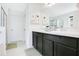 Bright bathroom with double sinks, a glass-enclosed shower, and modern fixtures at 161 Williamson Dr, Davenport, FL 33897