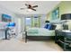 This bedroom features a ceiling fan, a TV, a desk, and windows offering a relaxing retreat at 161 Williamson Dr, Davenport, FL 33897