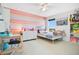 Bright bedroom featuring a colorful striped wall, twin bed, desk, and plenty of storage at 161 Williamson Dr, Davenport, FL 33897
