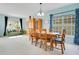 Bright dining room with a wooden table, hutch, and big windows, offering a charming space for meals at 161 Williamson Dr, Davenport, FL 33897