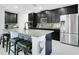Modern kitchen featuring a breakfast bar island, granite countertops, and stainless steel appliances at 161 Williamson Dr, Davenport, FL 33897