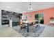 Bright kitchen featuring dark cabinets, stainless appliances, a large island with seating, and access to the outdoor patio at 161 Williamson Dr, Davenport, FL 33897