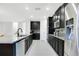 Well-equipped kitchen with sleek black cabinetry, stainless steel appliances, granite countertops, and stylish backsplash at 161 Williamson Dr, Davenport, FL 33897