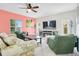 Cozy living room boasts an electric fireplace, TV, and large windows providing lots of natural light at 161 Williamson Dr, Davenport, FL 33897