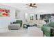 Inviting living room with comfortable seating, neutral carpet, and a glimpse into the adjacent kitchen and dining areas at 161 Williamson Dr, Davenport, FL 33897