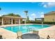 Community pool with a charming clubhouse, outdoor seating, and a refreshing swimming area at 161 Williamson Dr, Davenport, FL 33897