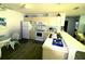 Efficient kitchen with white appliances, a breakfast bar, and ample cabinet space at 1650 Duran Dr, The Villages, FL 32162