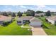 A well-maintained single-Gathering home with green lawn, landscaping, and a two-car garage at 1733 Oakville Pl, The Villages, FL 32162