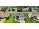 Aerial view of house and neighborhood, showcasing well-maintained lawns and surroundings at 1733 Oakville Pl, The Villages, FL 32162