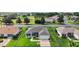 An aerial view showcasing the property's landscaping, proximity to the road, and neighborhood at 1733 Oakville Pl, The Villages, FL 32162