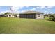 Spacious backyard and enclosed patio with ample space and lush green grass at 1733 Oakville Pl, The Villages, FL 32162