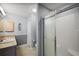 Well-lit bathroom featuring a glass shower door and vanity at 1733 Oakville Pl, The Villages, FL 32162