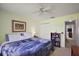 Cozy bedroom with pale yellow walls, neutral carpet, ceiling fan, and built-in bookcase at 1733 Oakville Pl, The Villages, FL 32162