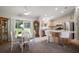 Bright dining area and island bar with kitchen in the background at 1733 Oakville Pl, The Villages, FL 32162