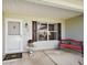 Inviting front porch with red bench and decorative accents at 1733 Oakville Pl, The Villages, FL 32162
