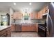 Bright kitchen featuring light wood cabinets and stainless steel appliances at 1733 Oakville Pl, The Villages, FL 32162