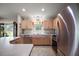 Bright kitchen with light wood cabinets, tile floors, and modern appliances at 1733 Oakville Pl, The Villages, FL 32162