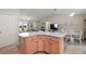 Open-concept living and dining area with hardwood floors and plenty of natural light at 1733 Oakville Pl, The Villages, FL 32162