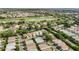 Aerial view of a residential area near a golf course and a lake, highlighting the community's location at 17428 Se 82Nd Albemarle Ave, The Villages, FL 32162