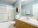 Bathroom with a shower and a vanity with towels and a small shelf at 17428 Se 82Nd Albemarle Ave, The Villages, FL 32162