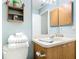 Clean bathroom vanity with stacked towels and rustic shelving at 17428 Se 82Nd Albemarle Ave, The Villages, FL 32162