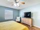 Bright bedroom with natural light, ceiling fan, and comfortable furnishings at 17428 Se 82Nd Albemarle Ave, The Villages, FL 32162