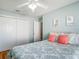 Bedroom with a white ceiling fan and closet, showcasing simple, clean design at 17428 Se 82Nd Albemarle Ave, The Villages, FL 32162