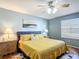 Relaxing bedroom with large window, ceiling fan, and coordinating furnishings at 17428 Se 82Nd Albemarle Ave, The Villages, FL 32162