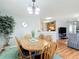 Cozy dining area with wood table and chairs, open to the kitchen and living room at 17428 Se 82Nd Albemarle Ave, The Villages, FL 32162