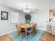 Cozy dining room featuring a wooden table with seating for six and soft natural light at 17428 Se 82Nd Albemarle Ave, The Villages, FL 32162