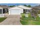 Cozy single-story home with a two-car garage, cute picket fence, and manicured landscaping at 17428 Se 82Nd Albemarle Ave, The Villages, FL 32162