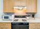 Bright kitchen features wood cabinets, laminate counters, and modern appliances at 17428 Se 82Nd Albemarle Ave, The Villages, FL 32162