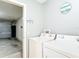 Functional laundry area leading into a garage for added convenience at 17428 Se 82Nd Albemarle Ave, The Villages, FL 32162