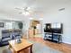 Open concept living area flows into the kitchen and dining area, featuring hardwood floors at 17428 Se 82Nd Albemarle Ave, The Villages, FL 32162