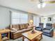 Comfortable living room with a plush leather sofa, recliner chairs, and natural light at 17428 Se 82Nd Albemarle Ave, The Villages, FL 32162
