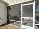 Close-up of screened-in lanai featuring comfortable seating and access to the backyard at 17428 Se 82Nd Albemarle Ave, The Villages, FL 32162