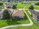 Aerial view showcasing house with screened patio, mature trees, and beautiful landscaping overlooking a golf course at 17769 Se 121St Terrace Rd, Summerfield, FL 34491