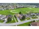 An aerial view highlighting the meticulously landscaped surroundings, lush golf course, and well-maintained neighborhood at 17769 Se 121St Terrace Rd, Summerfield, FL 34491