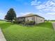 The backyard showcasing well-manicured lawn, manicured landscaping, and a screened patio at 17769 Se 121St Terrace Rd, Summerfield, FL 34491