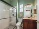 Bathroom featuring glass enclosed shower, tiled floors and wood vanity at 17769 Se 121St Terrace Rd, Summerfield, FL 34491