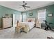 Bedroom showcasing neutral color palette, ceiling fan, and ensuite bathroom and walk-in closet at 17769 Se 121St Terrace Rd, Summerfield, FL 34491