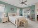 Cozy bedroom featuring soft carpet, ceiling fan, and sliding glass doors to outdoor area at 17769 Se 121St Terrace Rd, Summerfield, FL 34491