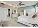 Bedroom showcasing neutral color palette, ceiling fan, and ensuite bathroom and walk-in closet at 17769 Se 121St Terrace Rd, Summerfield, FL 34491