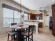 Cozy dining area featuring a round table, with barstool seating, and natural light at 17769 Se 121St Terrace Rd, Summerfield, FL 34491