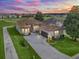 Beautiful home featuring a large driveway, bay windows, lush landscaping, and a two-car garage at 17769 Se 121St Terrace Rd, Summerfield, FL 34491