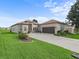 Well-manicured lawn and mature landscaping highlight this home at 17769 Se 121St Terrace Rd, Summerfield, FL 34491