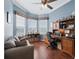 Home office featuring hardwood floors, ceiling fan, large desk and shelving at 17769 Se 121St Terrace Rd, Summerfield, FL 34491