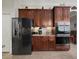 Spacious kitchen features dark wood cabinetry, stainless steel appliances, and plenty of storage space at 17769 Se 121St Terrace Rd, Summerfield, FL 34491