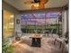 Relaxing screened-in lanai with fire pit and golf course view at 17769 Se 121St Terrace Rd, Summerfield, FL 34491